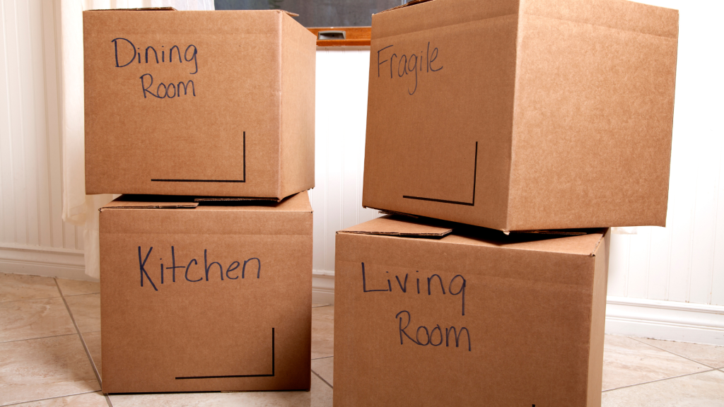 Moving boxes labelled Dining Room, Kitchen, Living Room and Fragile