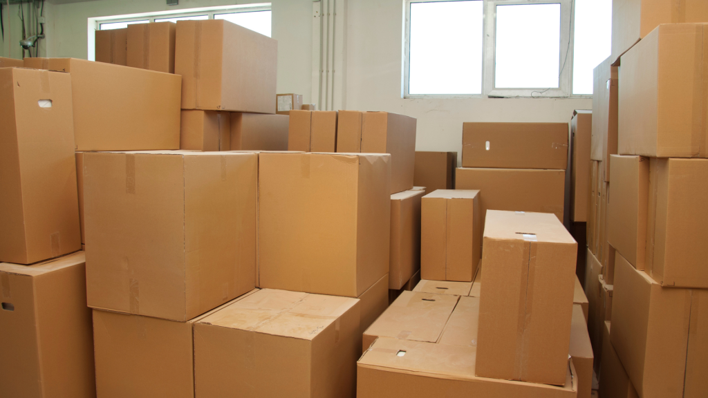 Rows of taped cardboard moving boxes stacked in a storeroom